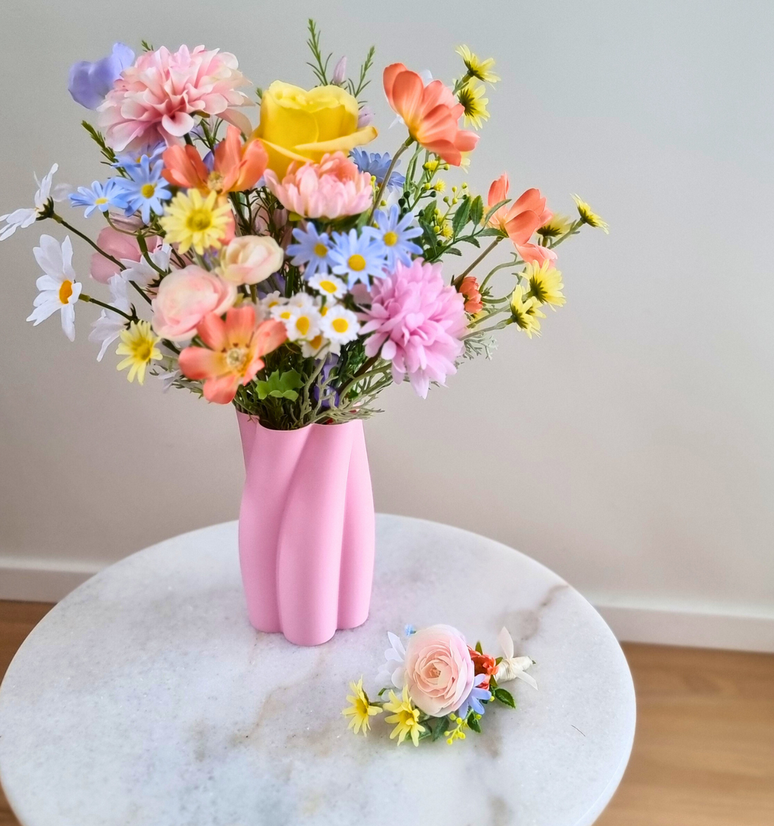 A whimsical pastel bouquet of roses, daisies, and wildflowers
