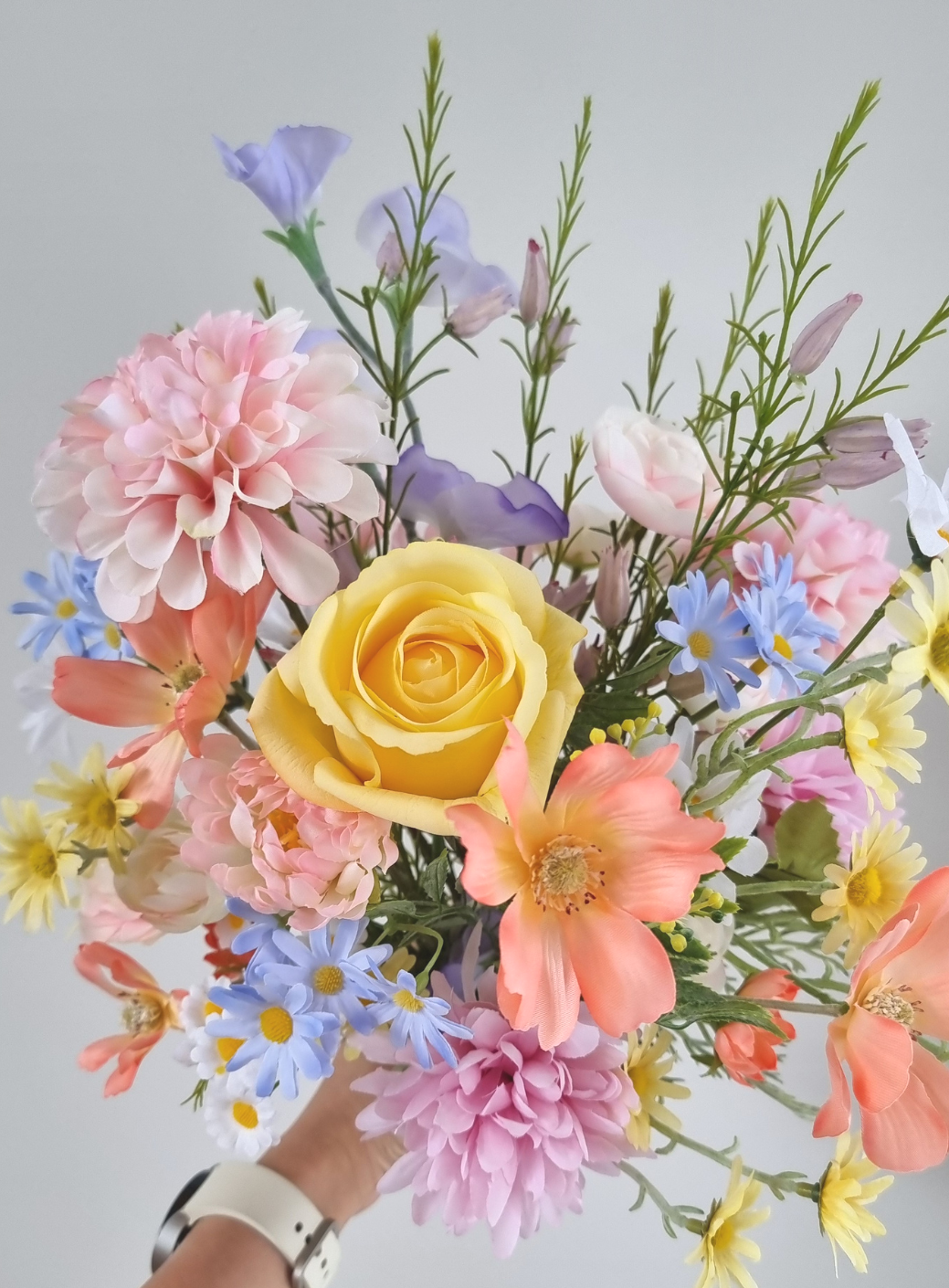 A Whimsical bouquet of pastel wildflowers and roses